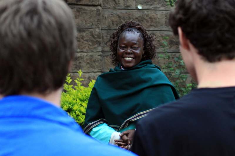 a woman in a green robe smiling