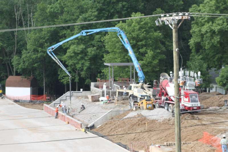 a crane pouring concrete into a construction site