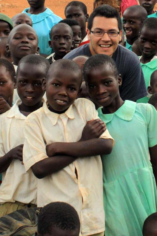a man standing next to a group of children