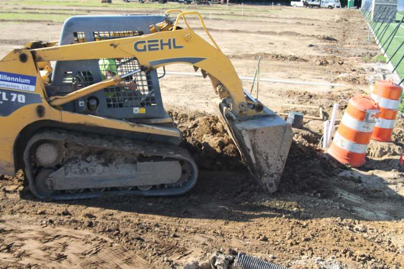 a bulldozer digging a hole in the dirt