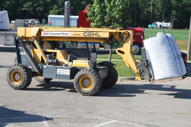 a yellow construction vehicle with a large loader