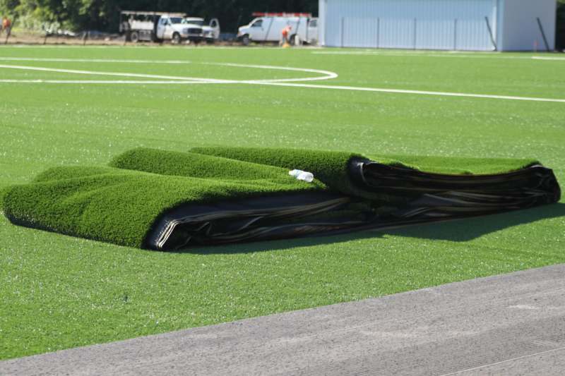 a rolled up green grass on a football field