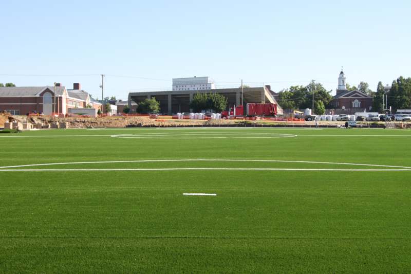 a football field with a building in the background
