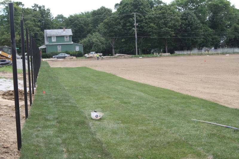 a dirt field with a person standing on it