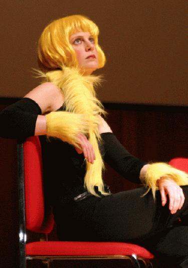 a woman wearing a yellow wig and a black dress