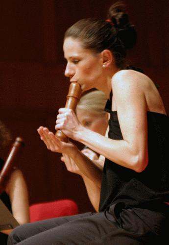 a woman blowing a flute