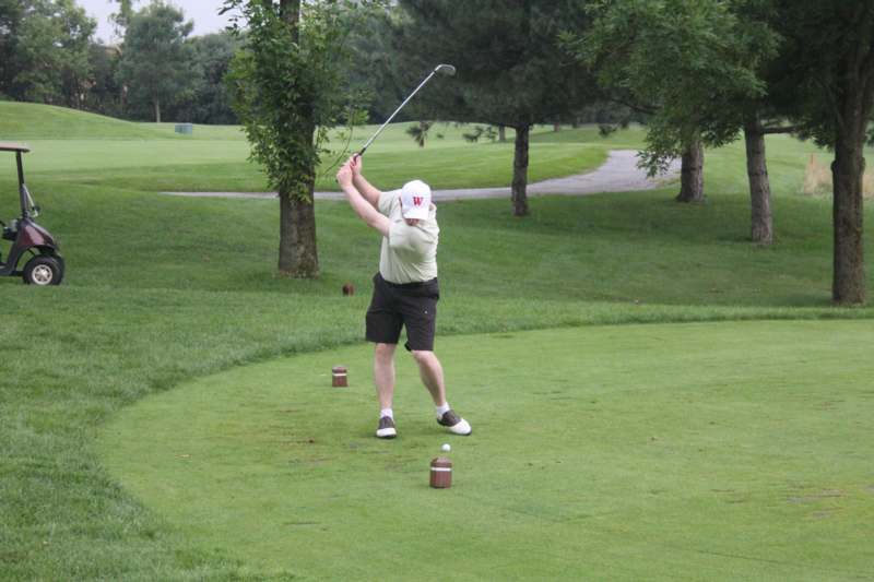 a man swinging a golf club