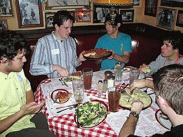 a group of people eating at a restaurant