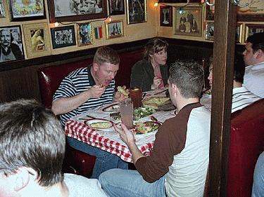 a group of people eating at a restaurant