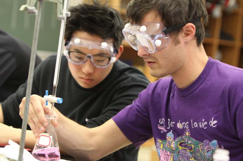 a pair of men wearing safety goggles