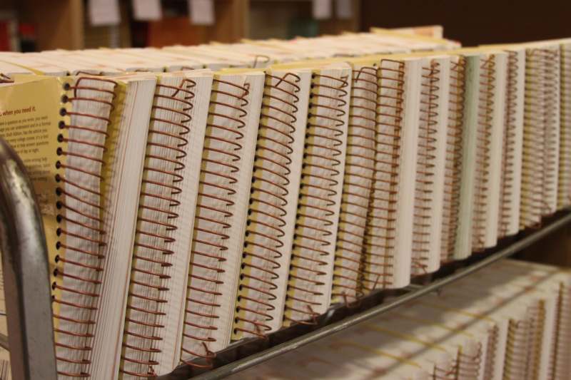 a row of spiral bound notebooks