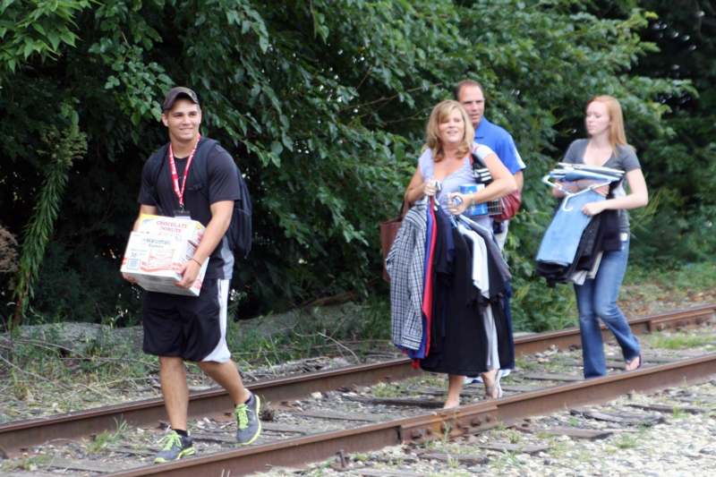 a group of people walking on train tracks
