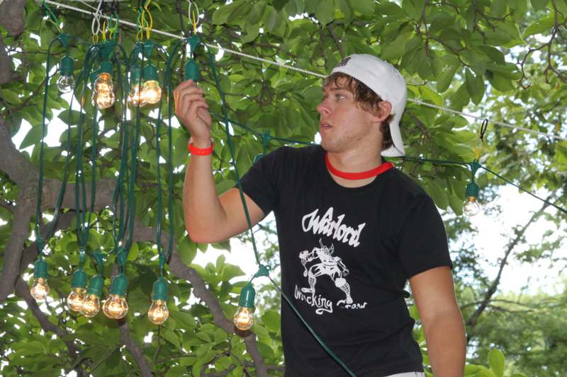 a man holding a string of lights