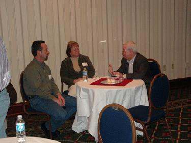 a group of people sitting at a round table