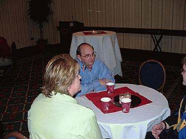 a man and woman sitting at a round table