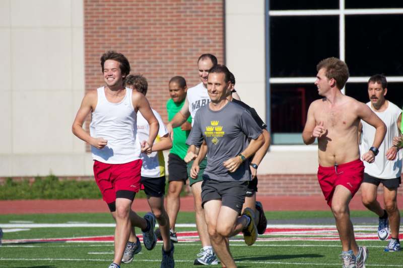 a group of men running on a field