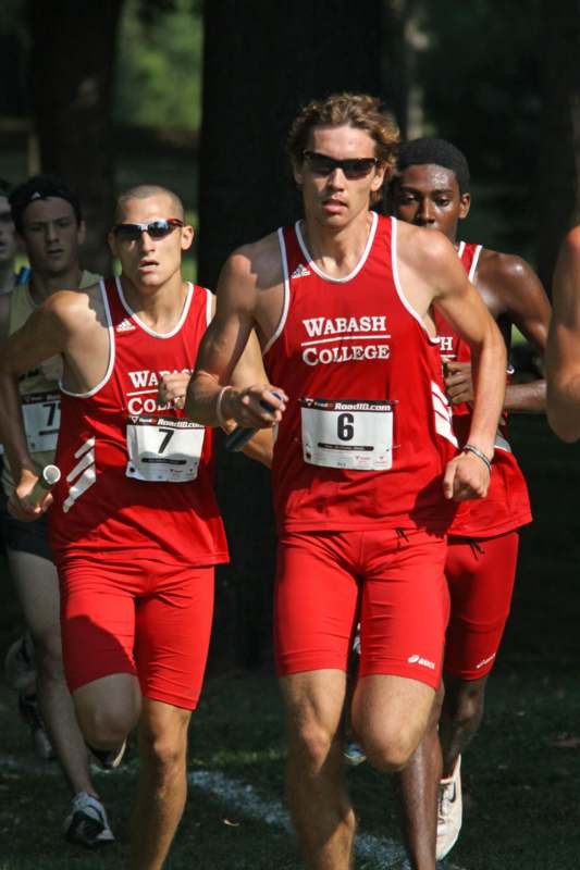 a group of men running in red uniforms