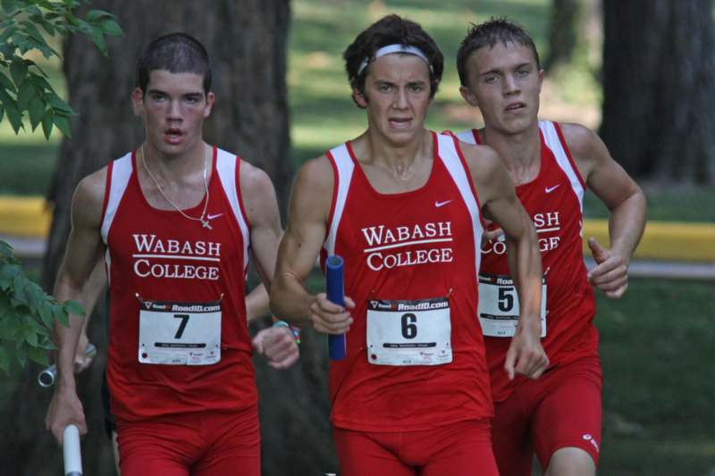 a group of men running in red uniforms