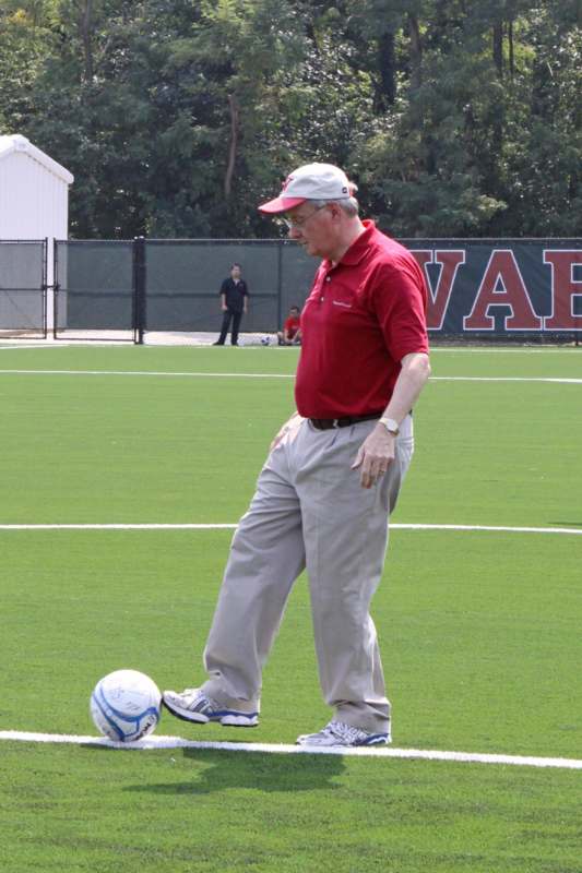 a man in a red shirt and white hat playing football
