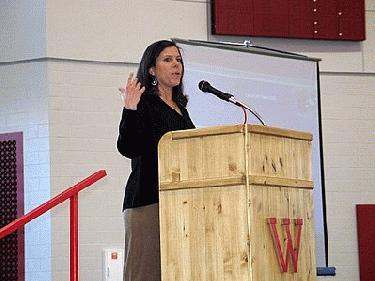 a woman standing at a podium