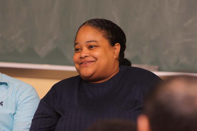 a woman smiling in a classroom