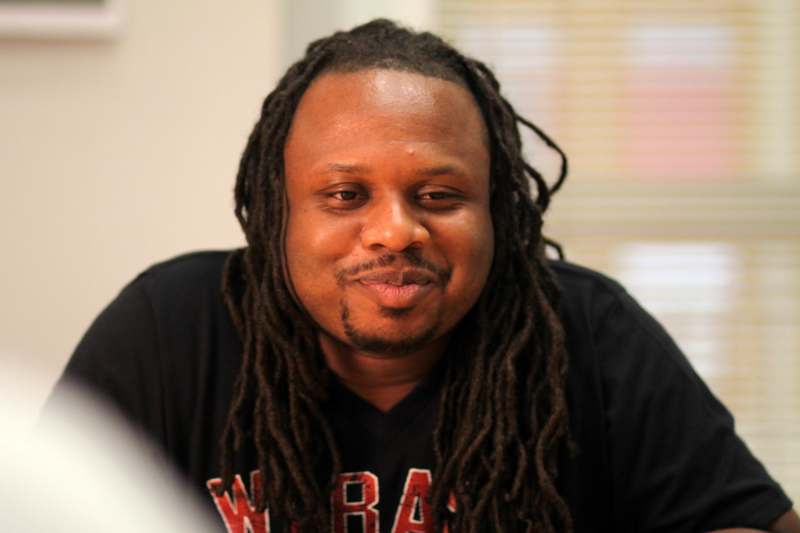 a man with long dreadlocks smiling