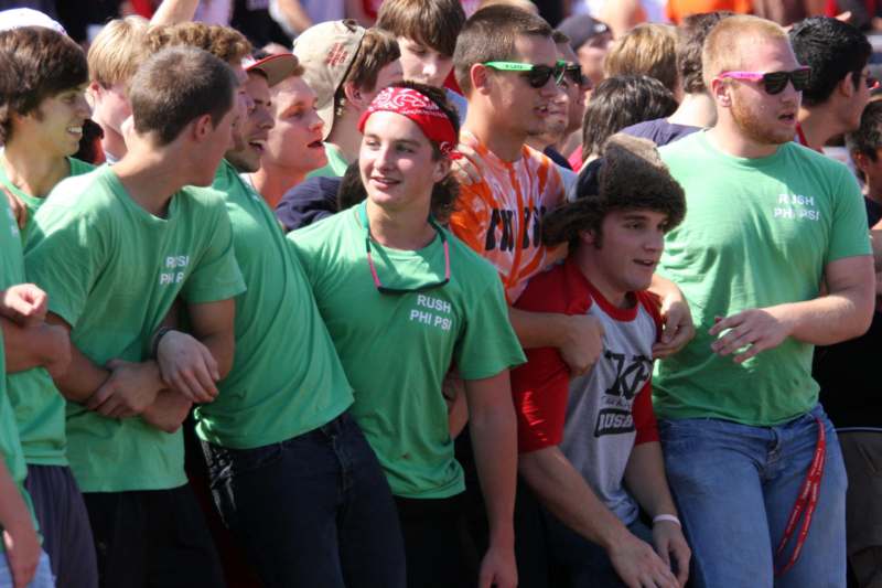 a group of people in green shirts