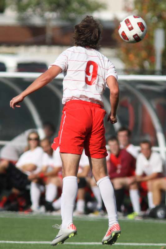 a man in red shorts and white shirt with number 9 on the back