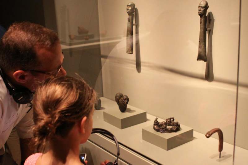 a man and woman looking at objects on display