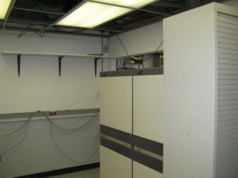 a room with white cabinets and wires