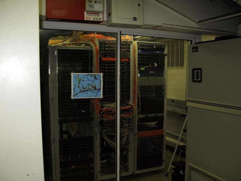 a computer server room with a glass door