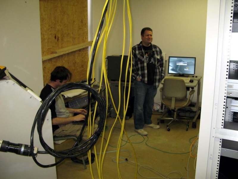 a group of men in a room with wires