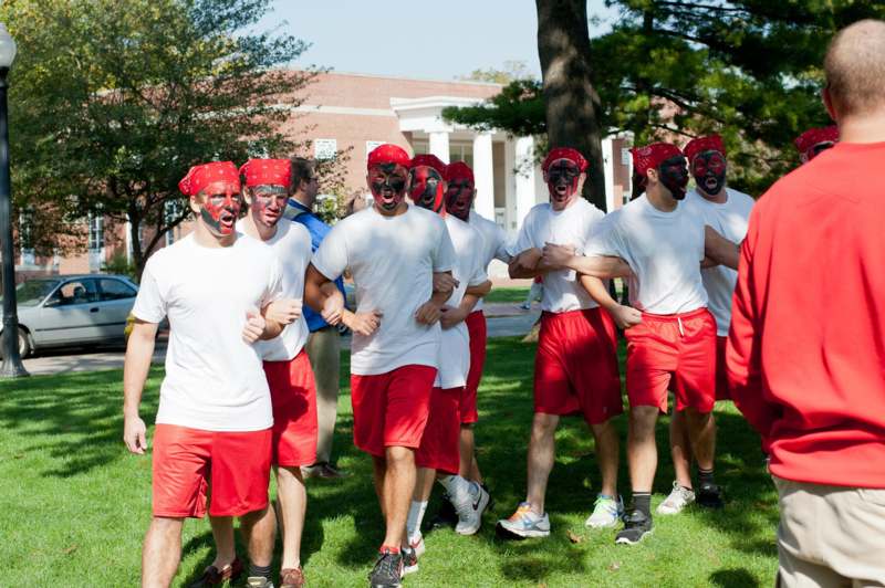 a group of people wearing red and white shirts and red bandanas