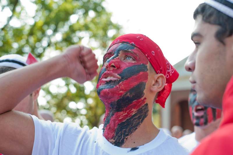 a man with black and red paint on his face