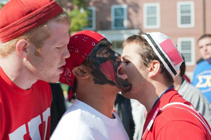 a group of men kissing each other