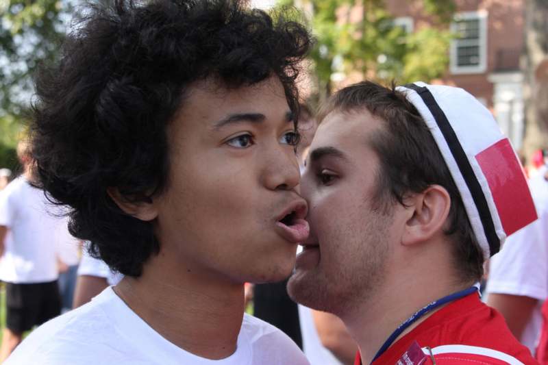 a man kissing another man's cheek