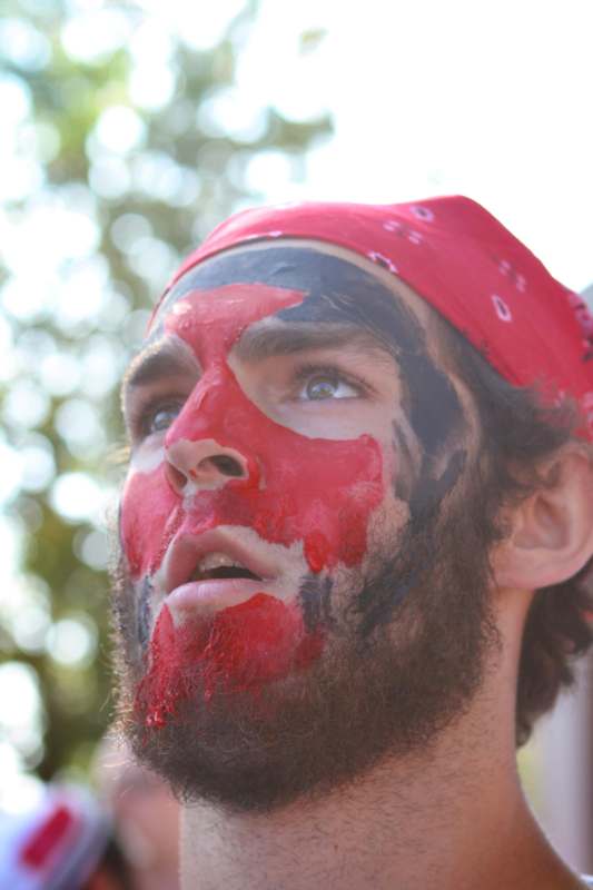 a man with red and black paint on his face