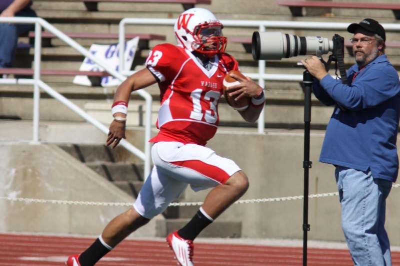a football player running with a camera