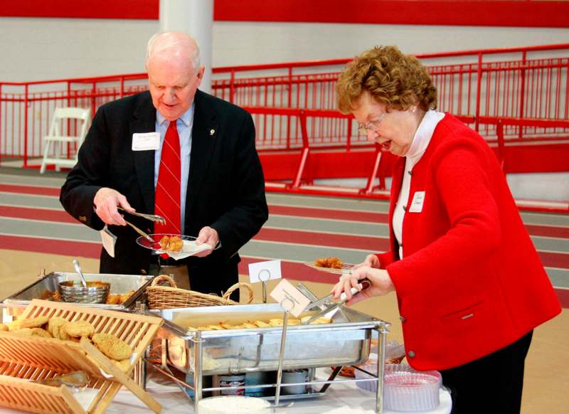 a man and woman serving food