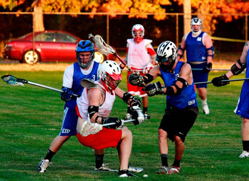 a group of men playing lacrosse