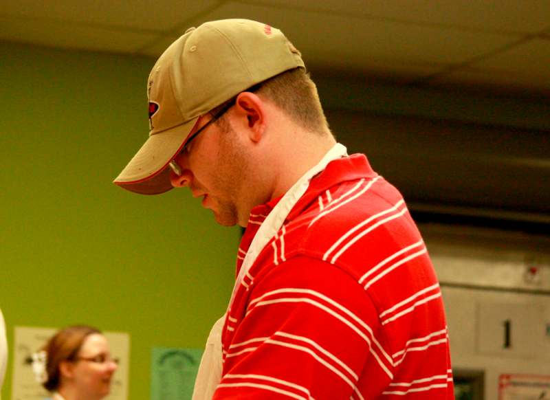 a man in a red shirt and hat