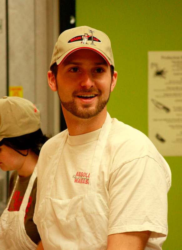 a man wearing a hat and apron