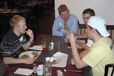 a group of men sitting at a table