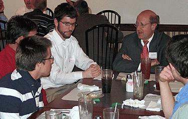 a group of people sitting around a table