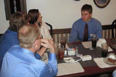 a group of people sitting at a table