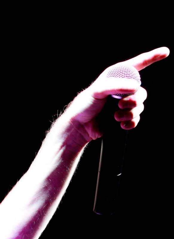 a hand holding a microphone