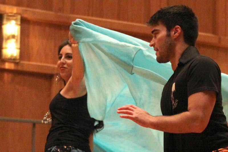 a man and woman holding a blue fabric