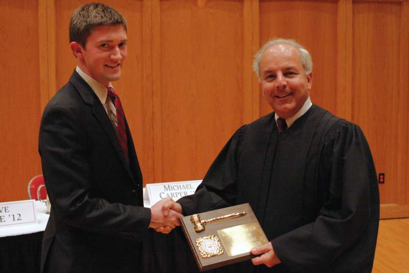 a man shaking hands with a judge
