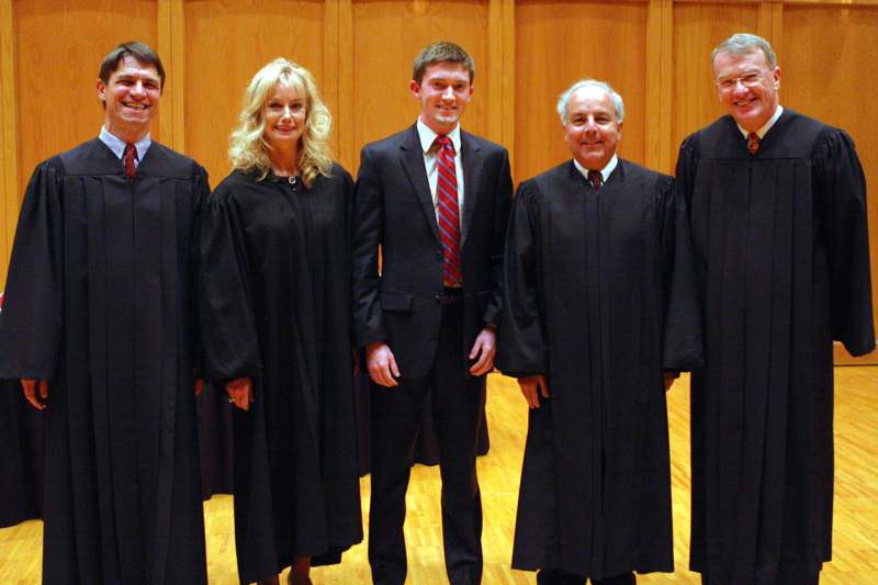 a group of people in black robes