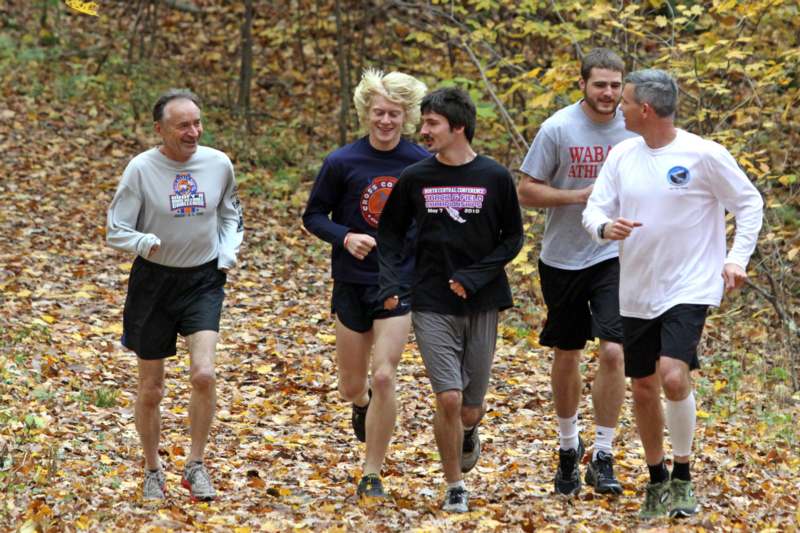 a group of men running in the woods
